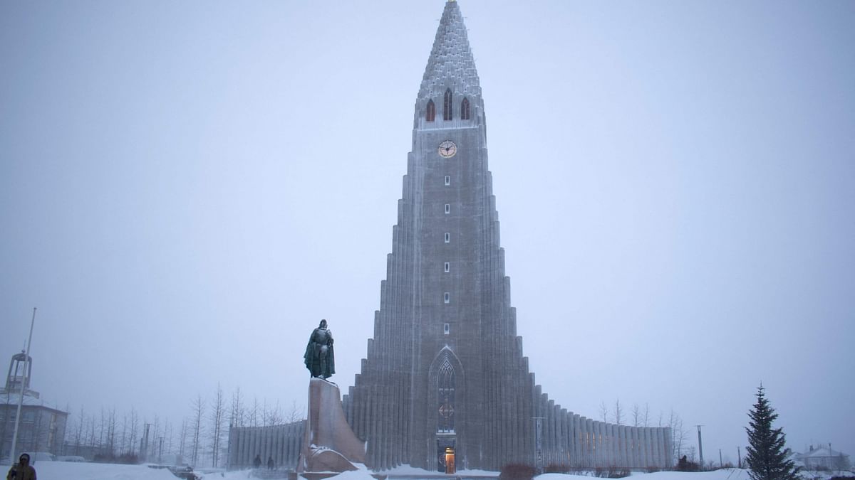 A photo taken on December 17, 2022 shows the Hallgrimskirkja church and the Leif Eriksson Memorial during snowfall in downtown Reykjavik, Iceland. Credit: AFP Photo