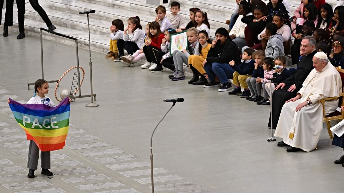 Artists perform as Pope Francis (R) attends a private audience with children and staff of the Santa Marta Dispensary, which is dedicated to helping infants in need, at Paul-VI hall in the Vatican on December 18, 2022. Credit: AFP Photo