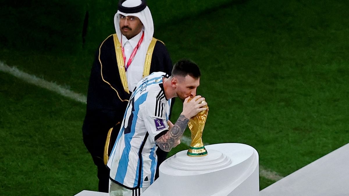 Lionel Messi kisses the World Cup trophy after being presented with the Golden Ball award. Credit: Reuters Photo