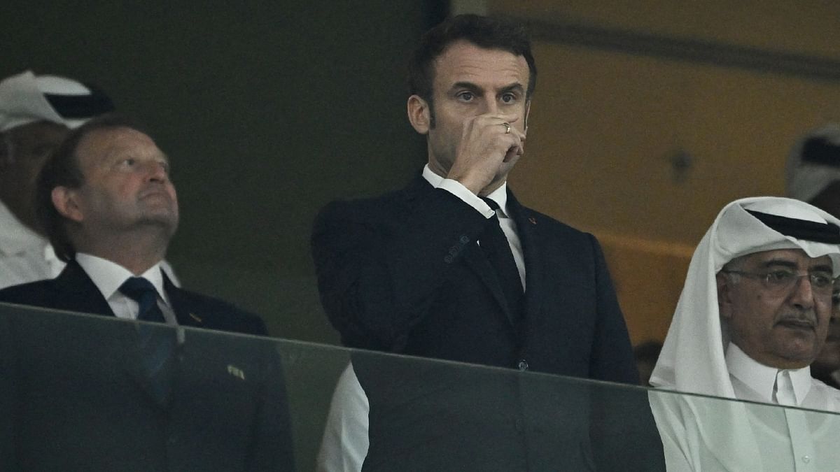 French President Emmanuel Macron gets clicked in the stands before the match. Credit: Reuters Photo
