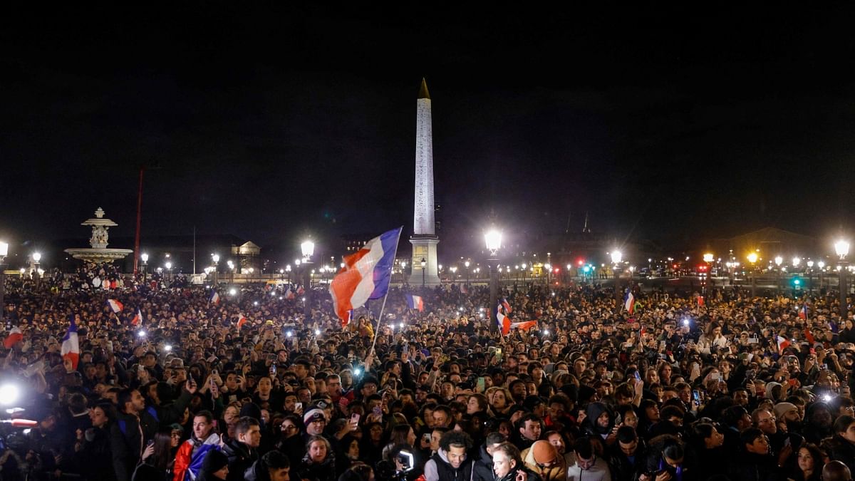 Fans wait at the Place de la Concorde for the arrival of the French national football team at the Hotel de Crillon, a day after the Qatar 2022 World Cup final match against Argentina, in central Paris on December 19, 2022. Credit: AFP Photo