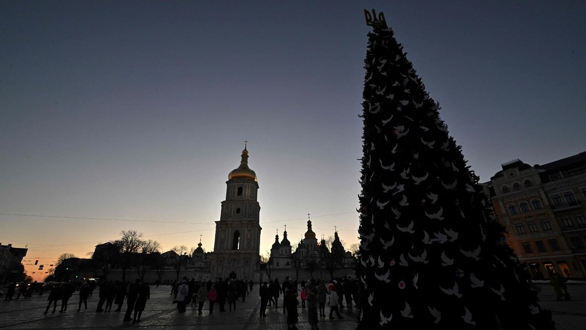 This picture shows a Christmas tree set up on Kyiv's Saint Sophia Square during the blackout hours prior to its inauguration ceremony on December 19, 2022. Credit: AFP Photo