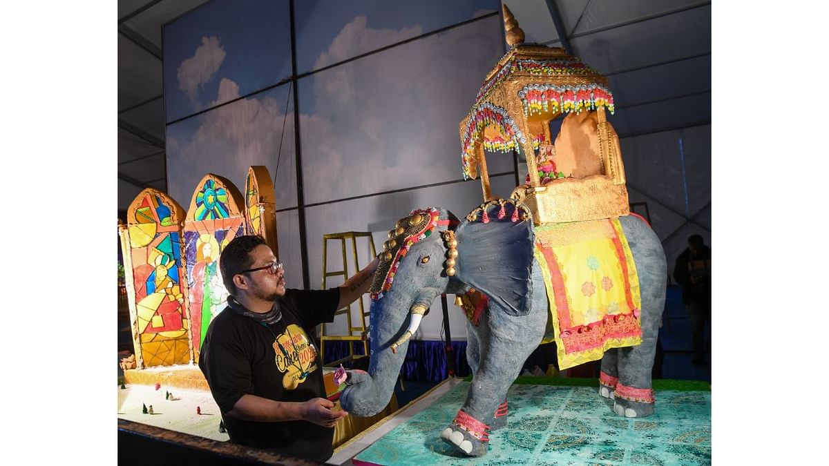 A baker is seen giving final touch to the Cake Sugar art displayed at the 48th Annual Cake Show, at St. Josphs School Grounds in Bengaluru. Credit: BH Shivakumar/DH Photo