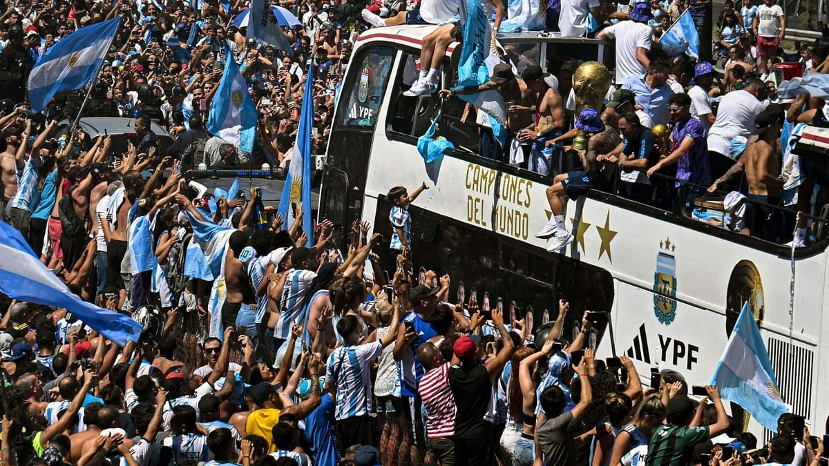 The victory parade was abruptly cut short after fans jumped on to the bus. Credit: AFP Photo