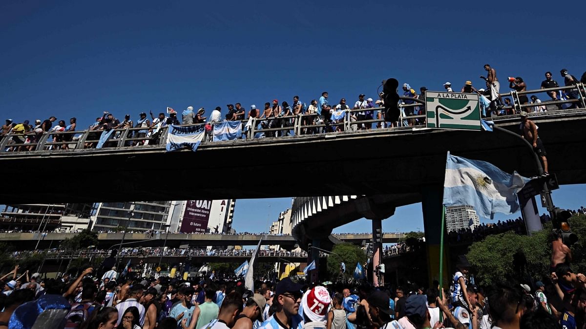 The parade was suspended shortly after two people jumped from a bridge onto the open-top bus carrying the players. Credit: AFP Photo