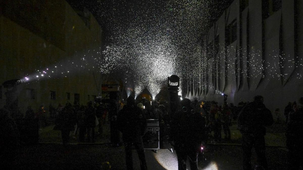 Attendees watch lighted biodegradable bubbles in the air, in Aix-en-Provence, France. Credit: AFP Photo