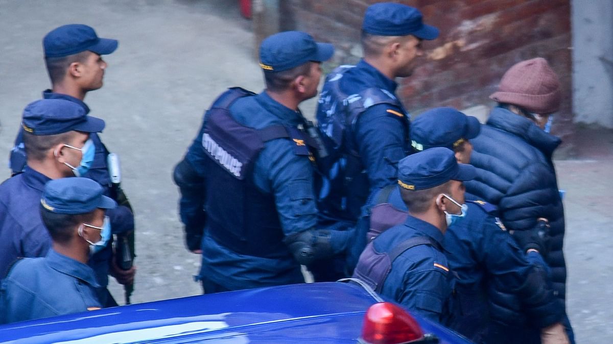 The French national was taken to immigration detention where he was escorted inside wearing a medical face mask, a brown woolly hat and a blue puffer jacket, ringed by police in bulletproof vests. Credit: AFP Photo