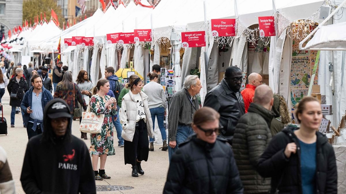 People shop for holiday and Christmas related gifts and items at the Annual Downtown Holiday Market in Washington, DC. Credit: AFP Photo