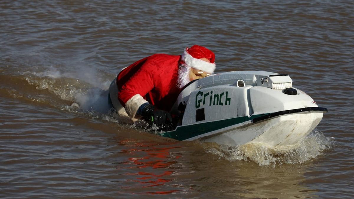 A man with a Santa mask rides in the water during the annual presentation of Waterskiing Santa on the Potomac River in Alexandria, Virginia. Credit: Reuters photo