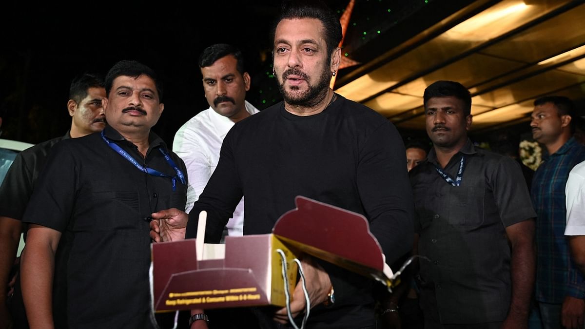 Salman is seen distributing cakes to the media persons. Credit: AFP Photo