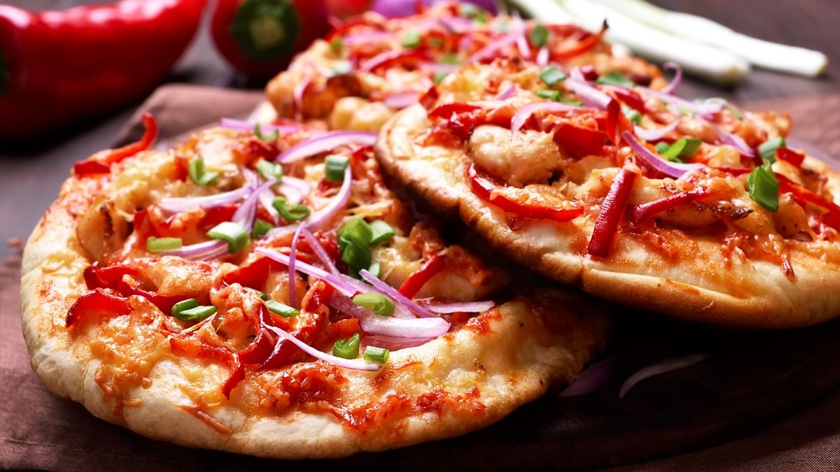 Pizza: Pizzas need no introduction and have been a staple at parties for decades. Whether veg or non-veg, there's so much goodness in a single slice and it’s almost impossible to eat just one. Credit: Getty Images