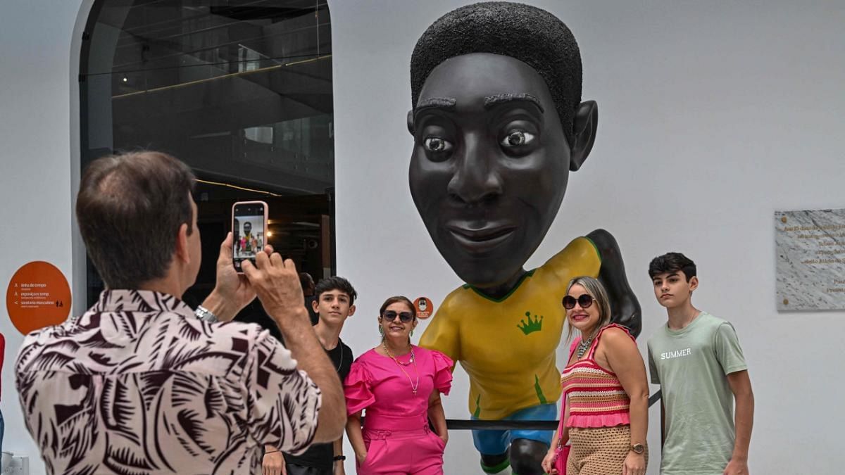 Visitors pose for a picture at the Pele Museum in Santos, Brazil, on December 27, 2022. Credit: AFP Photo