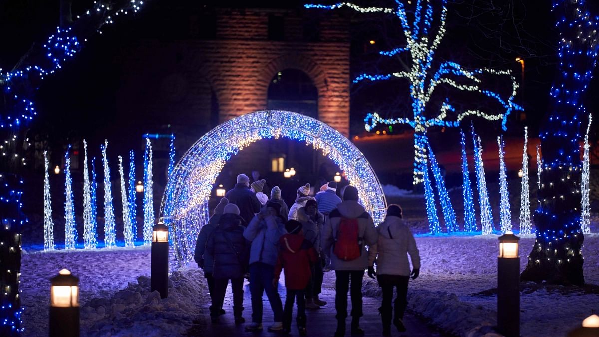 Tourists walk though a holiday light display at Niagara Falls in Niagara Falls, Ontario. Credit: AFP Photo