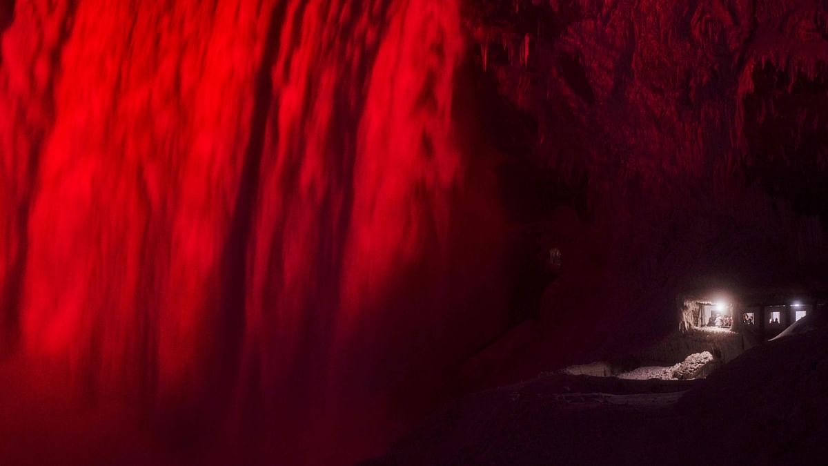 A light show illuminates the Horseshoe Falls in a red glow next to an observation deck in Niagara Falls. Credit: AFP Photo