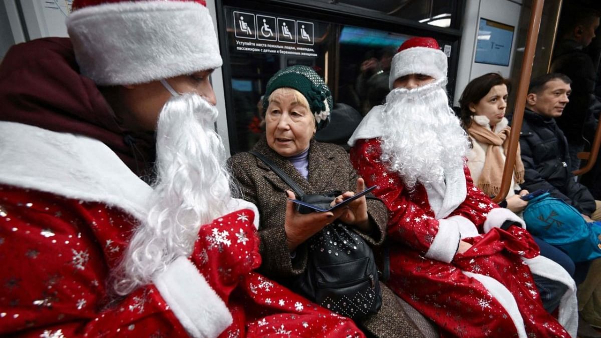 Employees of Moscow Metro dressed as Father Frosts take part in a Christmas and New Year flash mob for passengers in the Moscow underground on December 30, 2022. Credit: AFP Photo