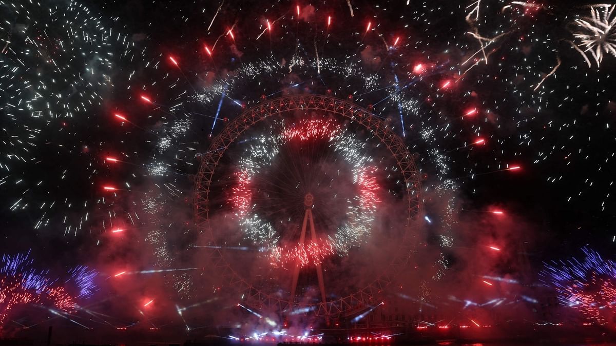 Fireworks explode around the London Eye during New Year's celebrations in central London just after midnight. Credit: AFP Photo