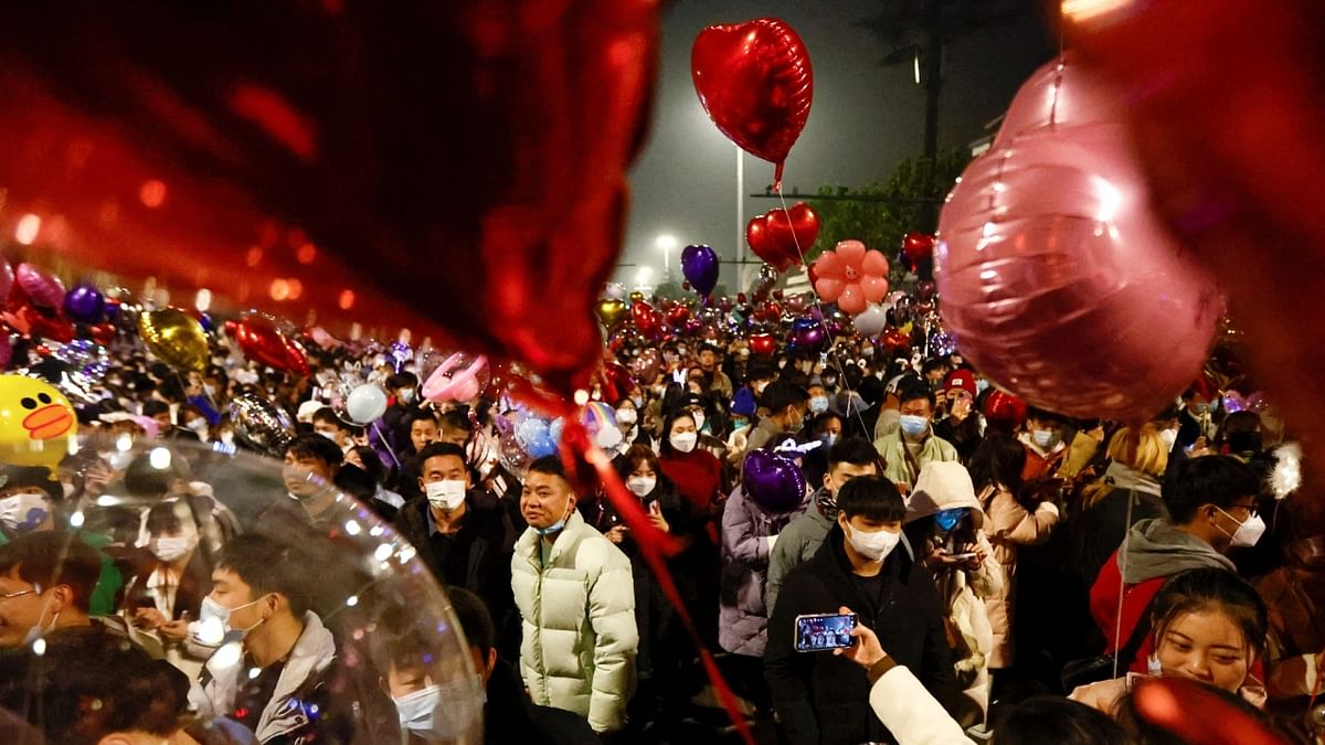 Many released balloons into the sky when the clocks struck midnight, as per tradition in the central Chinese city where the pandemic began three years ago, before grabbing selfies with their friends. Credit: Reuters Photo