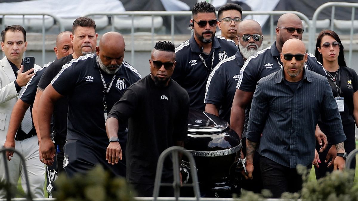 Pallbearers carry Pele's casket to the centre circle of his former club Santos' Vila Belmiro stadium. Credit: Reuters Photo