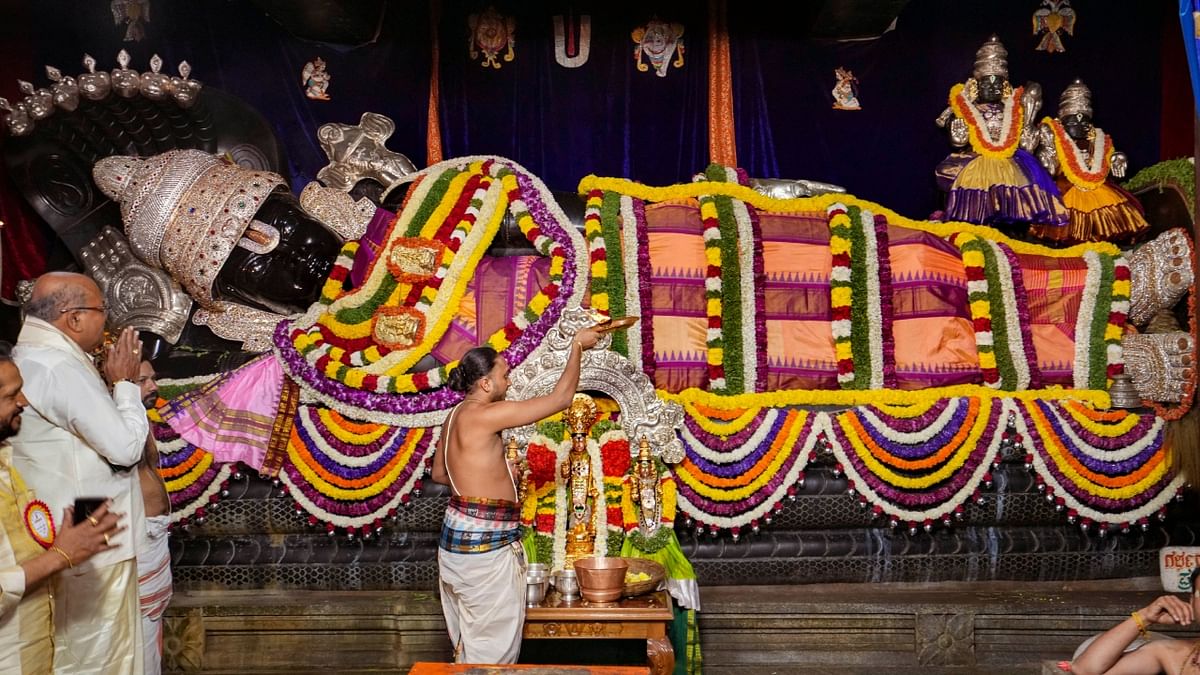 A priest performs 'aarti' of Lord Venkateswara on the occasion at a temple in Bengaluru. Credit: PTI Photo