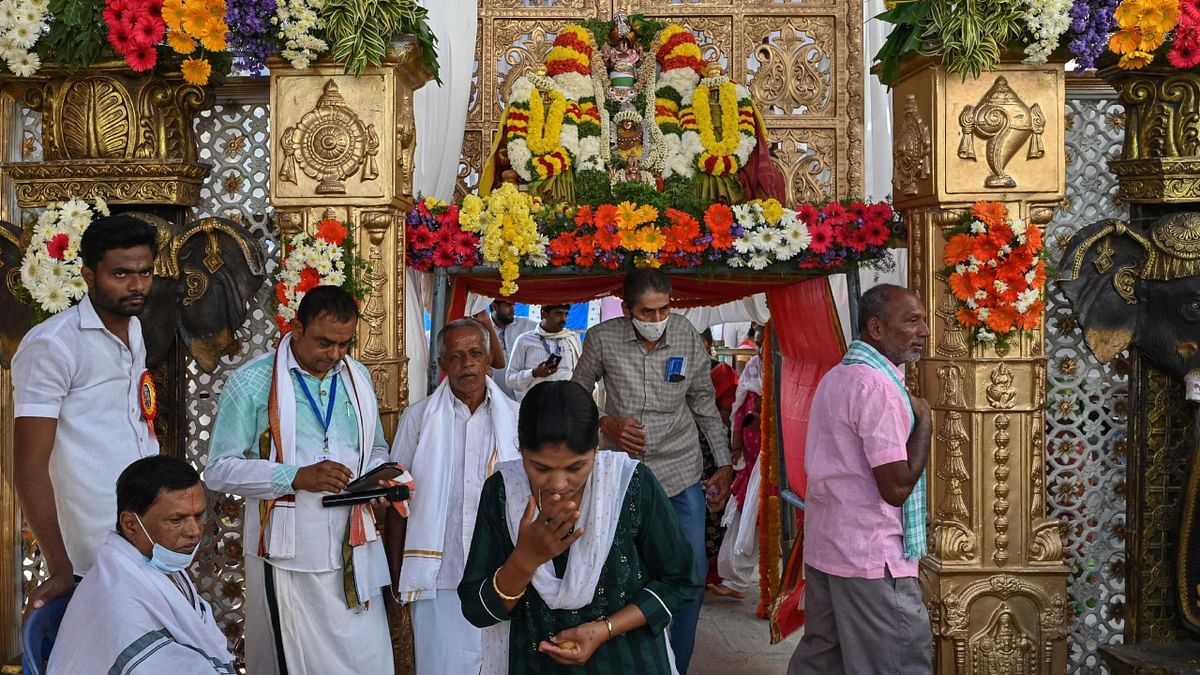 Devotees offer prayers to the divine deity of Shri Balaji at a temple on the occasion, in Bengaluru. Credit: AFP Photo