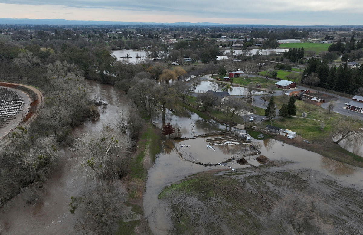 A view from a drone shows flooded areas around homes after rainstorms caused a levee to break, flooding Sacramento County roads and properties near Wilton, California, US. Credit: Reuters Photo