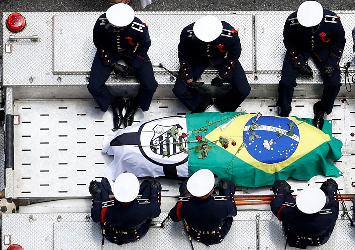 Members of the National Guard are pictured as the casket of Brazilian soccer legend Pele is transported by the fire department, from his former club Santos' Vila Belmiro stadium. Credit: Reuters Photo