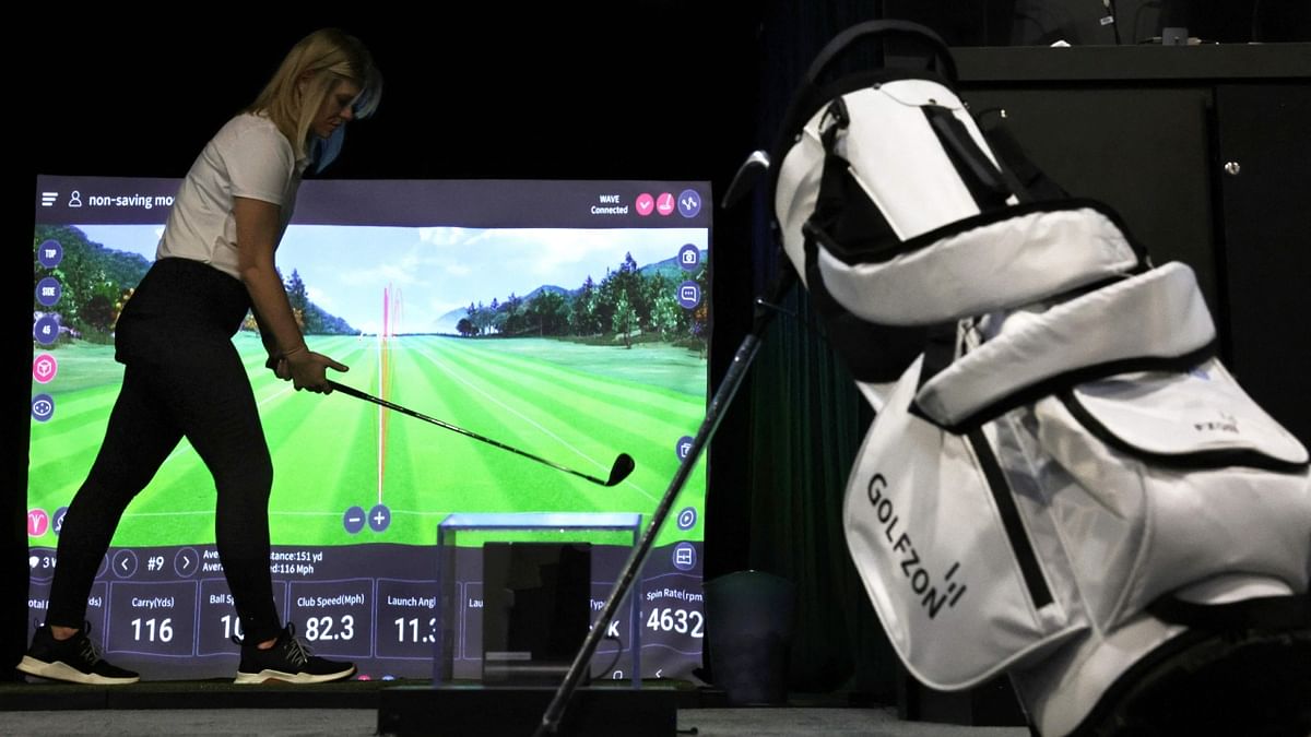 A Golfzon employee demonstrates the Wave golf simulator at CES 2023 on January 07, 2023. Credit: Getty Images via AFP