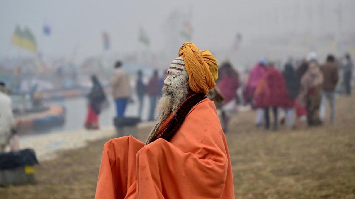 A Sadhu or a Hindu holy man prays after taking a holy dip in the waters of Sangam during the Magh Mela festival in Prayagraj. Credit: Reuters Photo