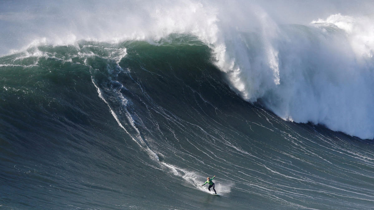 Brazilian skimboarder Lucas Fink rides a wave in Praia do Norte, Nazare. Credit: Reuters Photo