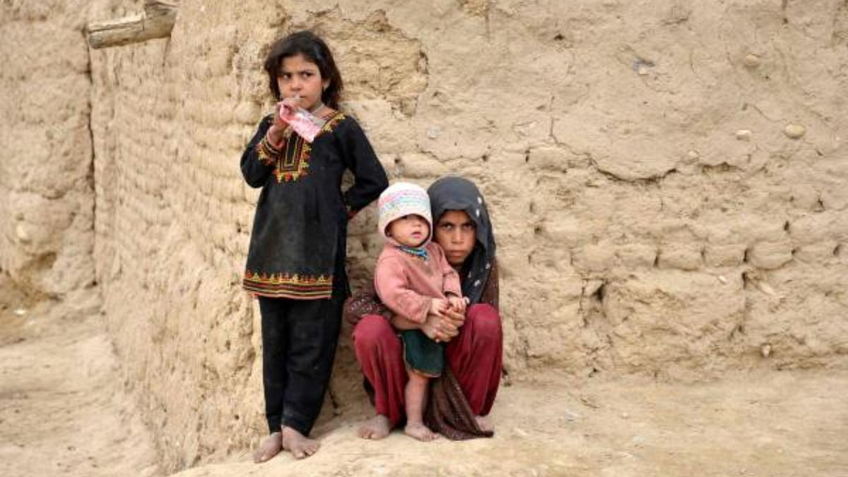 Afghan girls stand outside their house in Sangin district of Helmand. Credit: AFP Photo