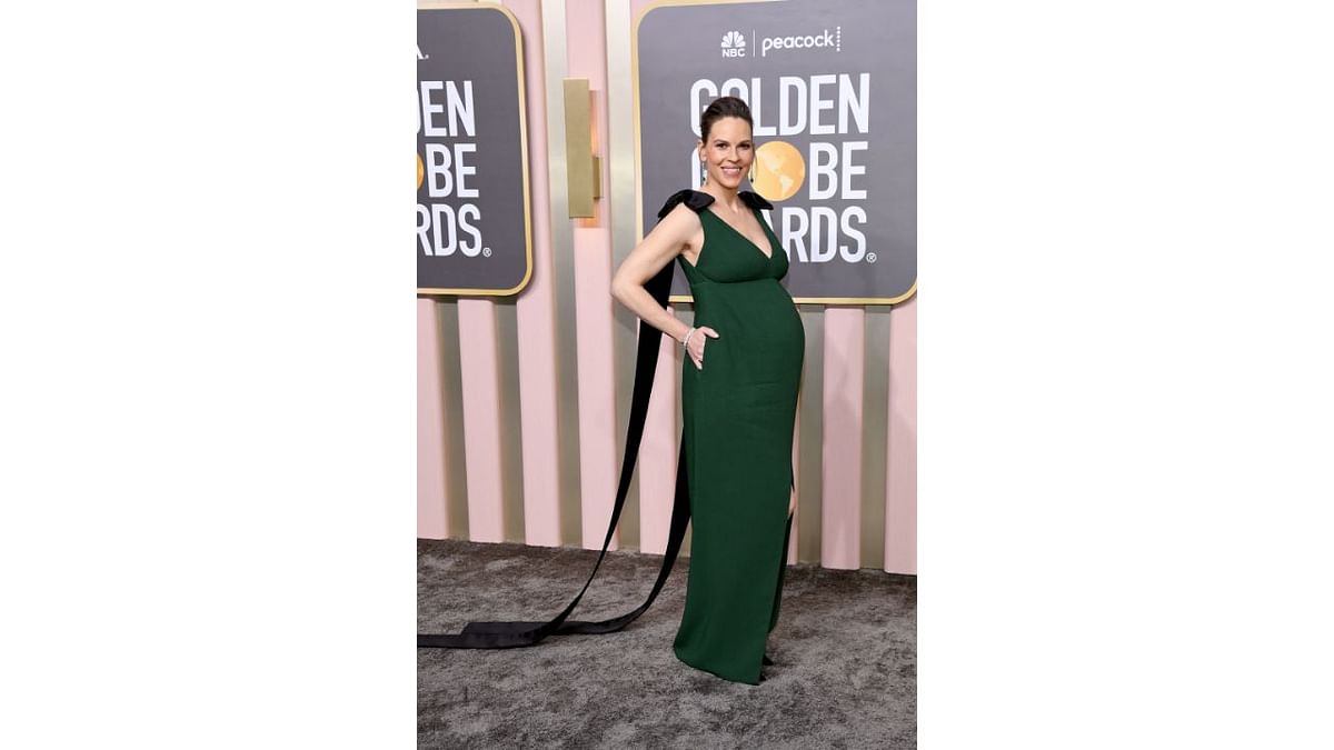 Hilary Swank, who is pregnant with twins, wowed in a dark green sleeveless Prada gown with pockets and black bows on the shoulders. Credit: AFP Photo