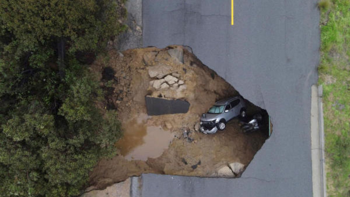 Several people had to be rescued after two vehicles fell into a sinkhole in Chatsworth, California. Credit: Reuters Photo