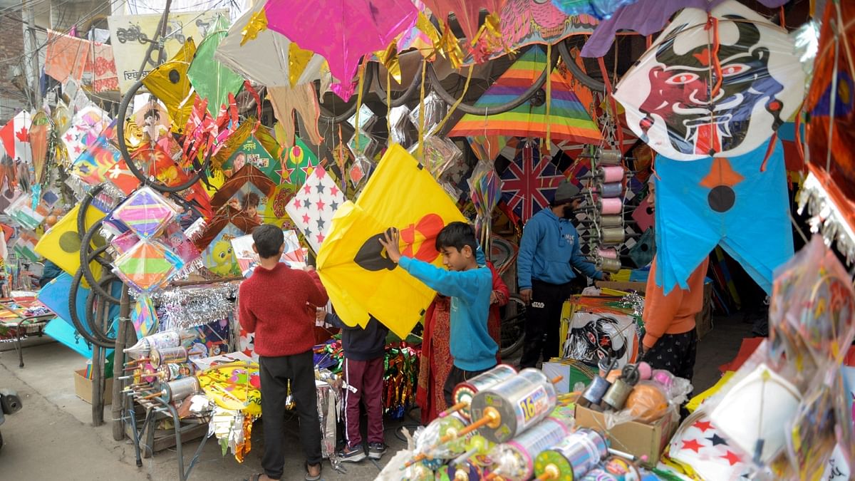 Every year, kite enthusiasts throng in large numbers to the markets to buy kites with pictures of their idols. Credit: AFP Photo