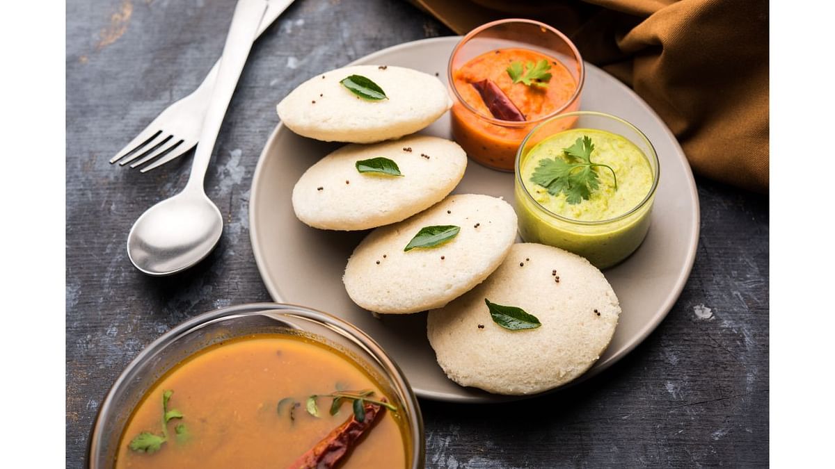 Idli & Sambhar: This savoury rice cake dish is made by steaming batter consisting rice and dals and is served with coconut chutney, tomato chutney and sambhar. Credit: Getty Images