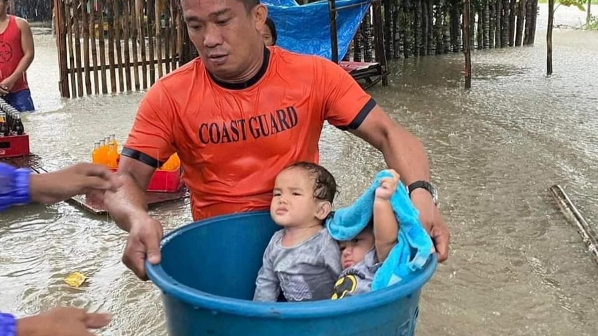 Children are being evacuated by rescue workers from the flooded areas in Zamboanga. Credit: AFP Photo