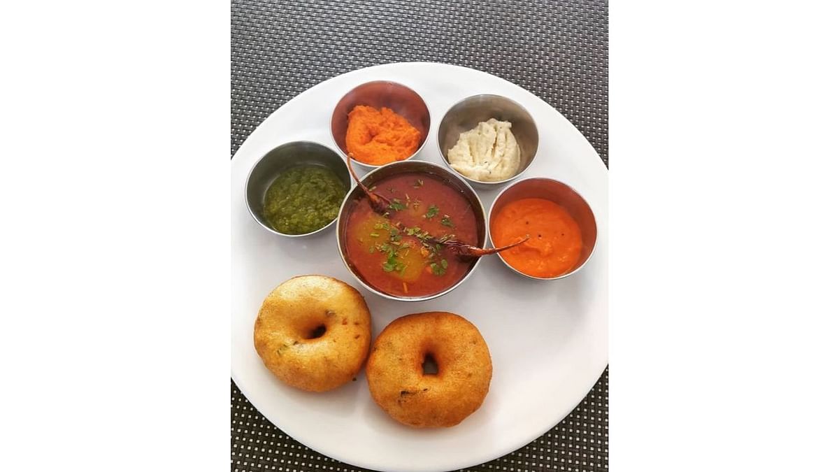 Vada: Medhu Vada, or lentil doughnut, is a crunchy snack mainly consumed for breakfast with pipping hot sambhar and coconut chutney. Its primary ingredient is urad dal or black gram lentils. Credit: Instagram/@shrivenkateswara_pureveg