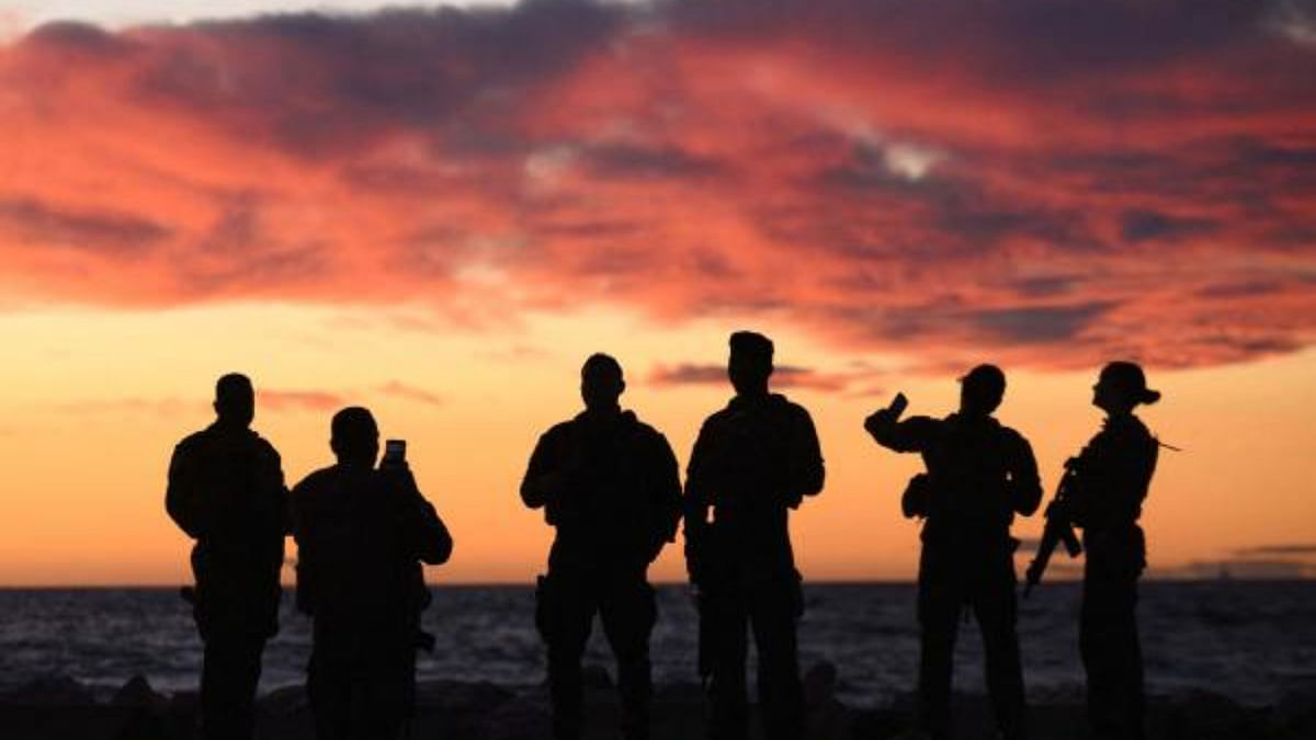 French soldiers watch the sunset in Marseille, southern France. Credit: AFP Photo
