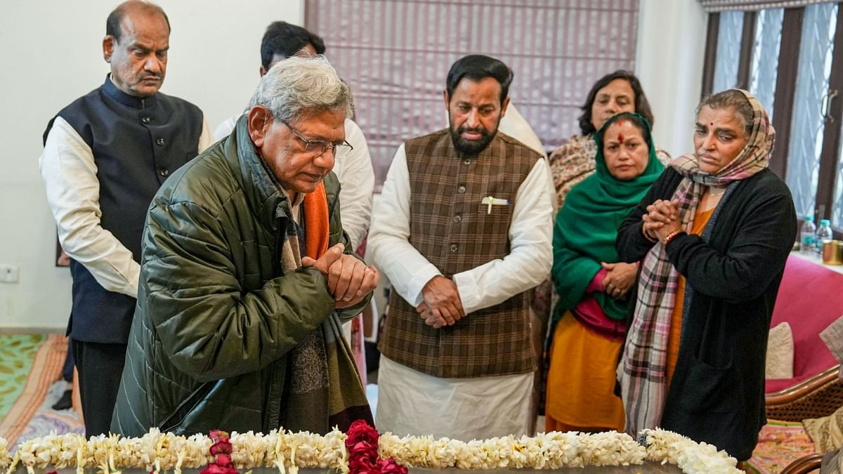 CPI(M) General Secretary Sitaram Yechury pays his last respects to former union minister Sharad Yadav, at Chhatarpur in New Delhi. Credit: PTI Photo