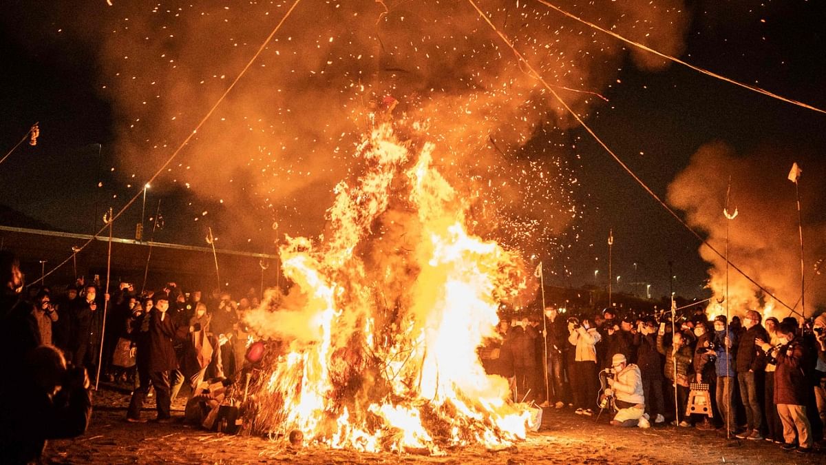 People burn New Year's pine decoration into the bonfire during the 'Oiso No Sagicho', a traditional Japanese fire festival held on the small New Year's Day, on the beach in Oiso, Kanagawa prefecture. Credit: AFP Photo