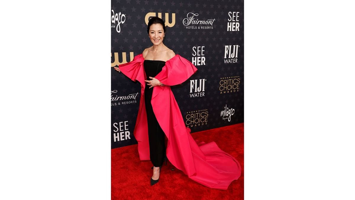 Michelle Yeoh mixed perk with sophistication in her plain black column dress with large and the fluttering sleeves that is pretty uncommon at the red carpet. Credit: AFP Photo