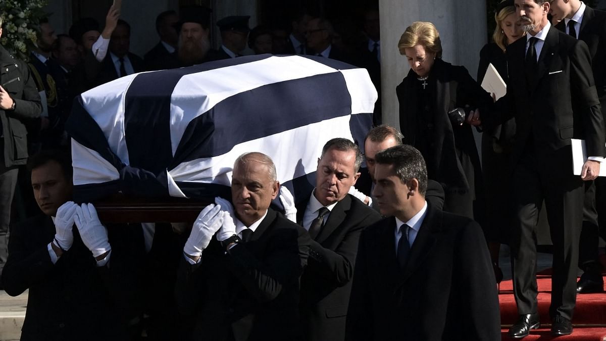 Pall-bearers carry the coffin in front of Greece's former Queen Anne-Marie (CTopR) and Pavlos, Crown Prince of Greece as they leave after the funeral service of former King of Greece Constantine II in the Metropolitan Cathedral of Athens. Credit: AFP Photo