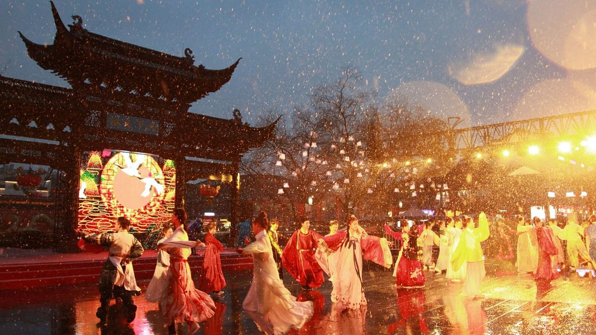 This photo taken on January 14, 2023 shows performers dancing during snowfall at a lantern show in Nanjing, in China's eastern Jiangsu province, ahead of the Lunar New Year of the Rabbit, which falls on January 22. Credit: AFP Photo