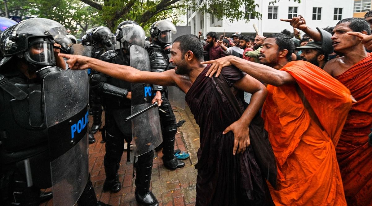 Anti-government demonstrators and university students scuffle with police during a protest demanding the release of Inter University Students' Federation leader Wasantha Mudalige, in Colombo. Credit: AFP Photo