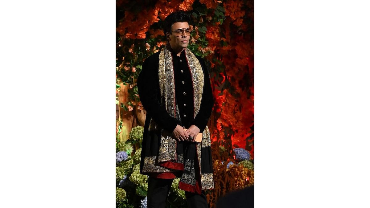 Karan Johar looked dapper in his black ethnic attire at Anant Ambani and Radhika Merchant's engagement ceremony. Credit: AFP Photo