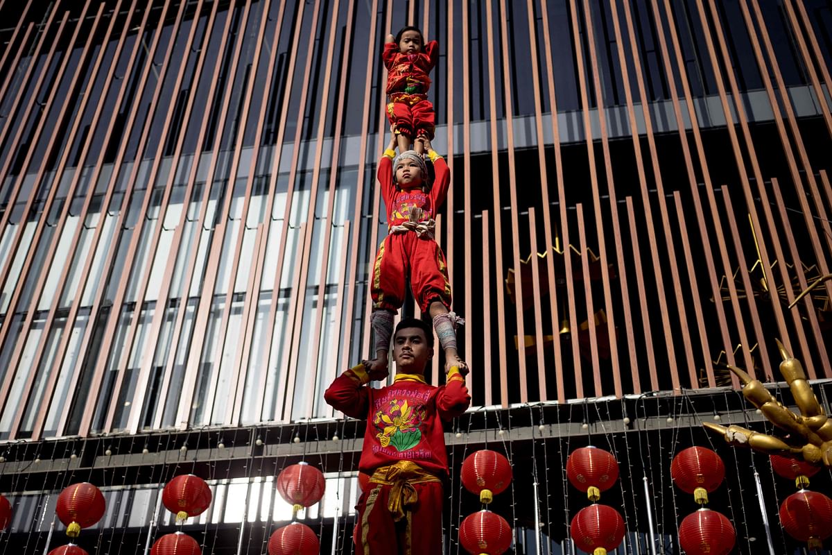 Young acrobats form a human tower during a performance on the eve of lunar new year in the Chinatown area of Bangkok. Credit: AFP Photo