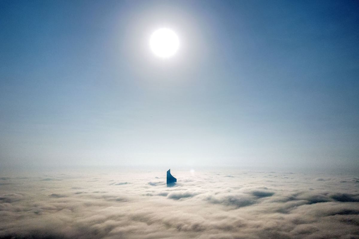 This aerial view shows the top of al-Hamra tower through heavy fog obscuring the rest of the skyline of Kuwait City. Credit: AFP Photo