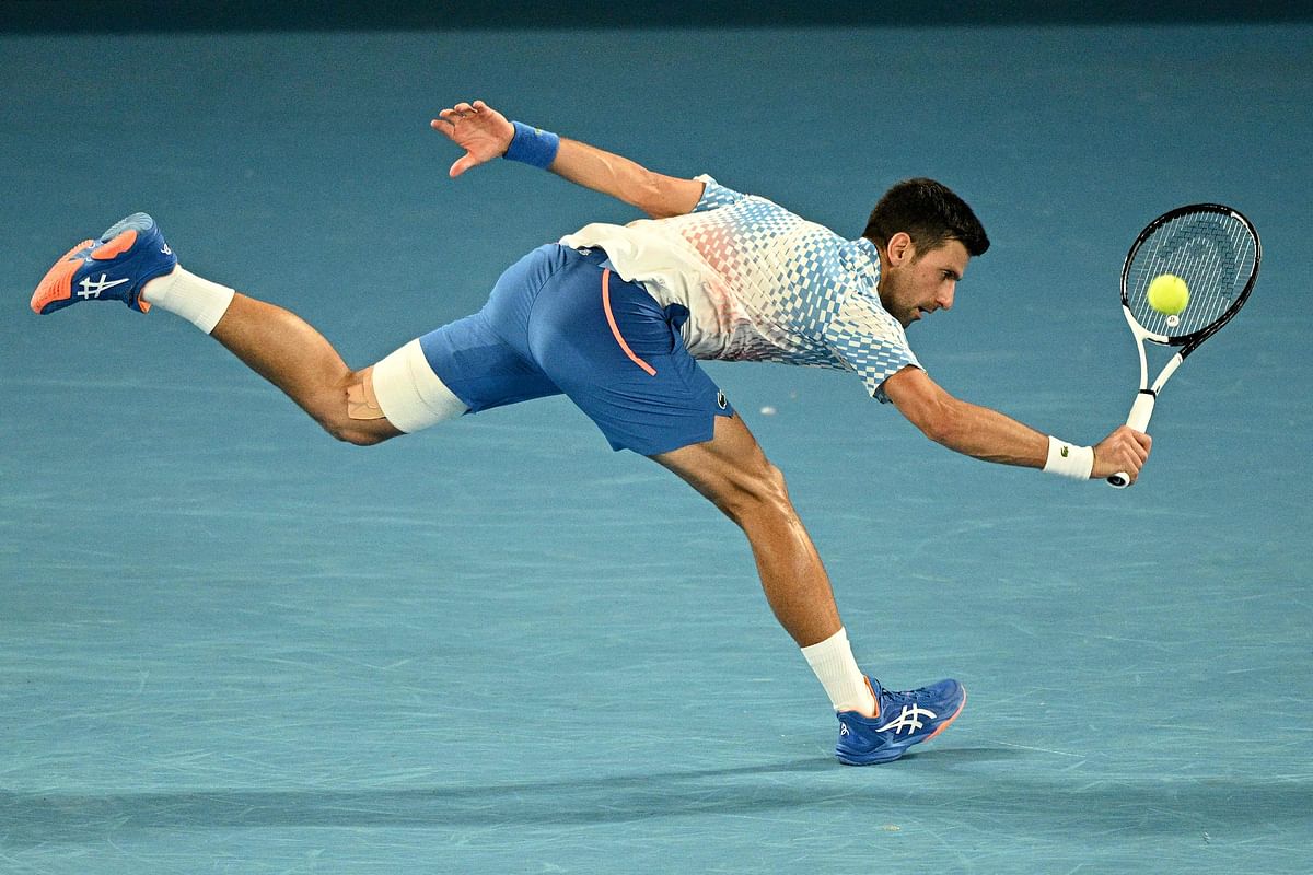 Serbia's Novak Djokovic hits a return against Australia's Alex De Minaur during their men's singles match on day eight of the Australian Open tennis tournament in Melbourne. Credit: AFP Photo