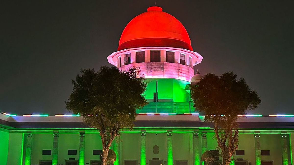 The Supreme Court of India is illuminated in the colours of national flag on the Republic Day's eve, in New Delhi. Credit: PTI Photo