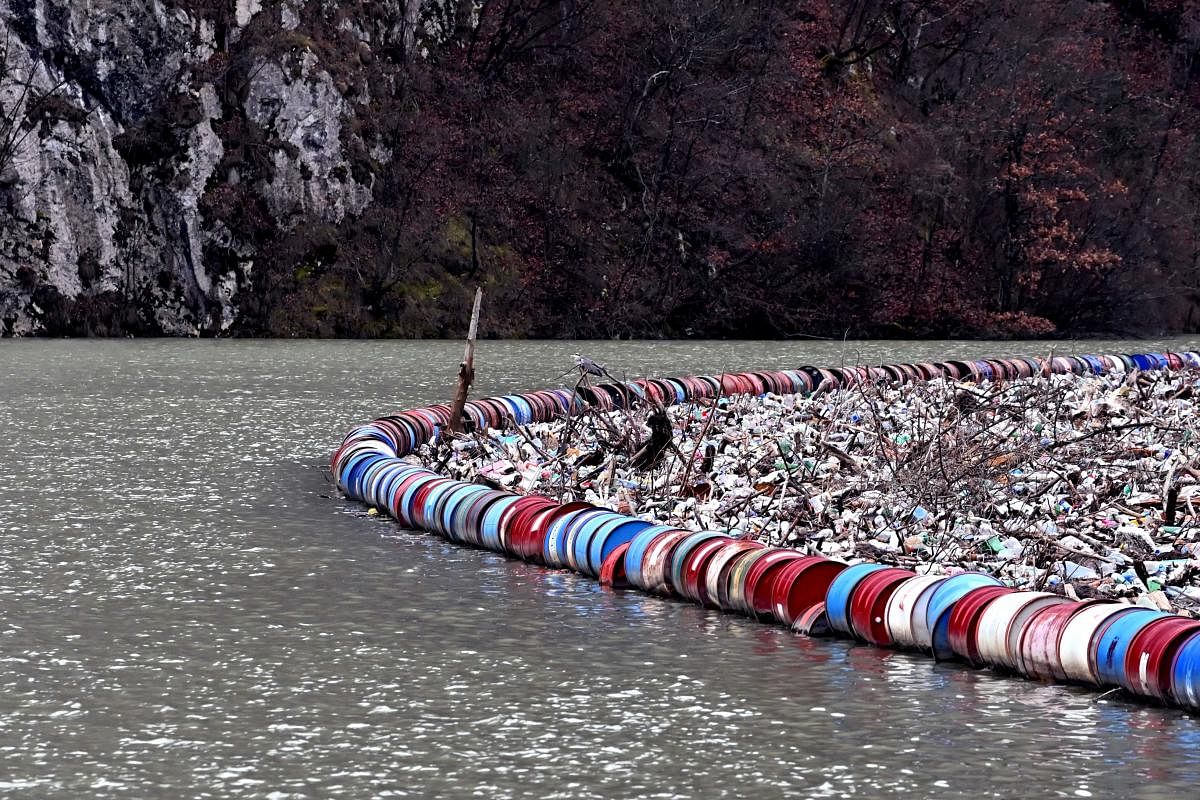The waste and debris were carried into the Drina River from neighbouring municipalities in Bosnia and the neighbouring countries of Serbia and Montenegro after the recent floods. Local authorities fear that the defences will break down under the increased load and give way, causing another ecological disaster and endangering the nearby Visegrad hydroelectric plant. Credit: AFP Photo