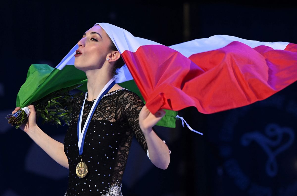 Italy's Sara Conti celebrates with the Italian flag during the winner's ceremony of the Pairs - Free Skating competition of the 2023 ISU European Figure Skating Championships in Espoo, on January 26, 2023. Credit: AFP Photo
